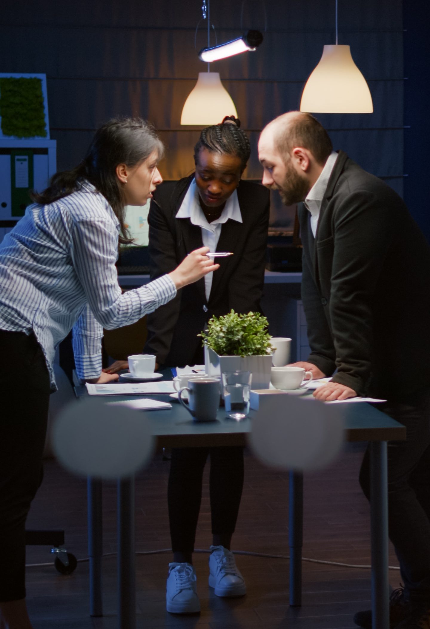 Focused leader woman enter in office meeting room lean on conference table