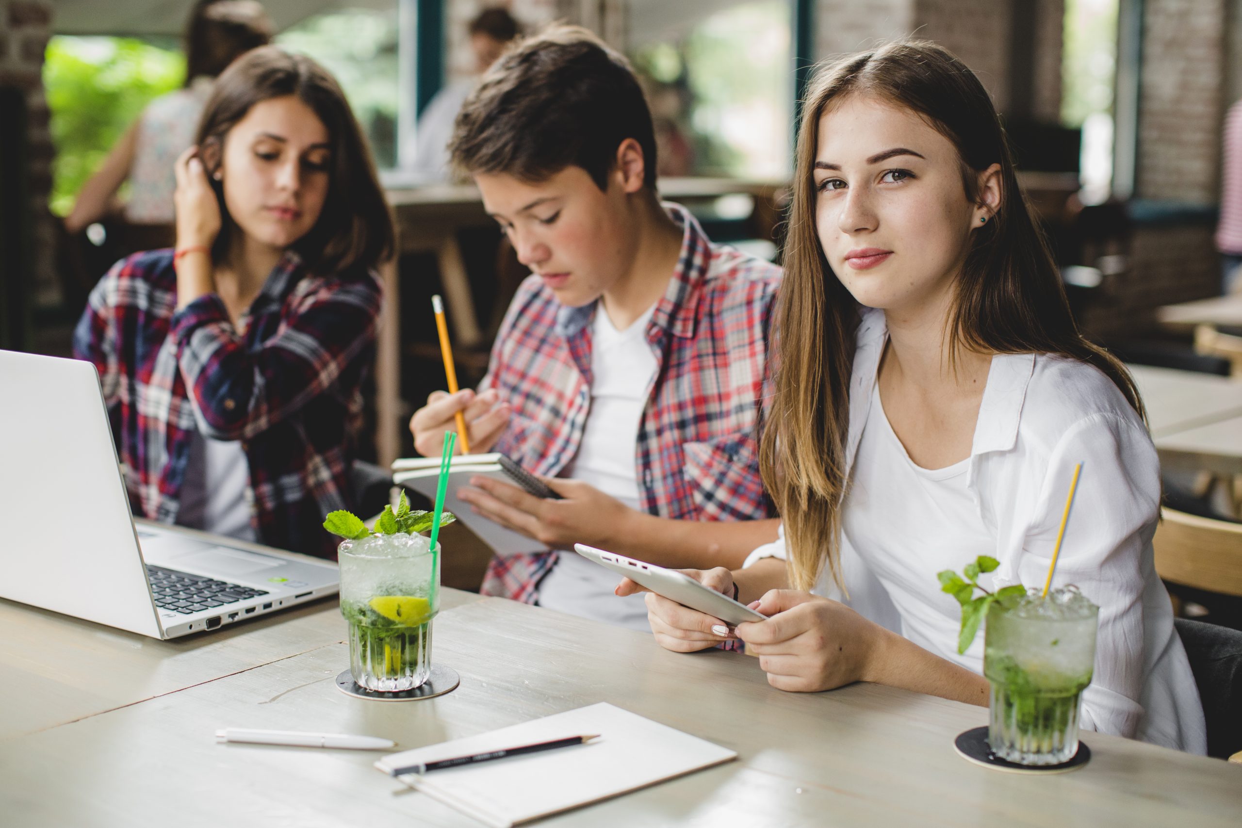 three-students-with-gadgets-cafe